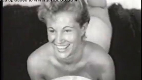 Nude model with a gorgeous figure takes part in a porn photo shoot of the 50s